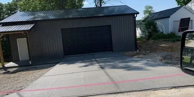 Detached garage build with fresh concrete driveway
