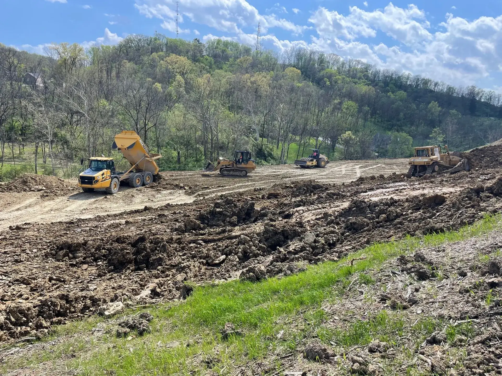 Full excavation fleet cutting a hillside building site