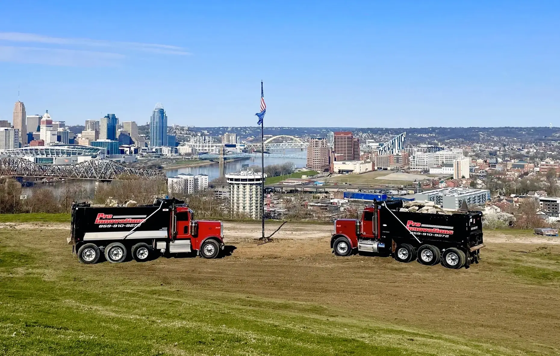 Pro Innovations trucks above the Cincinnati skyline